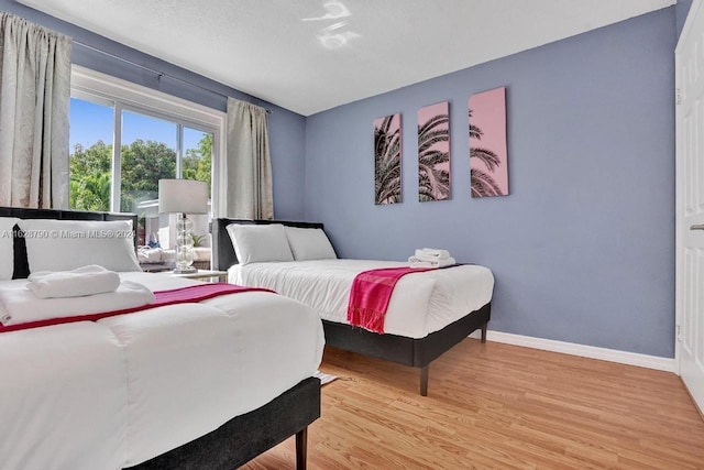 208 SW 2nd Ave, Hallandale Beach, FL 33009 - bedroom featuring light wood finished floors and baseboards