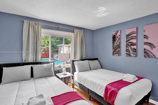 208 SW 2nd Ave, Hallandale Beach, FL 33009 - bedroom featuring a textured ceiling and wood finished floors