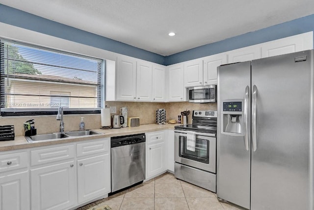 208 SW 2nd Ave, Hallandale Beach, FL 33009 - kitchen featuring appliances with stainless steel finishes, light tile patterned floors, white cabinetry, light countertops, and recessed lighting