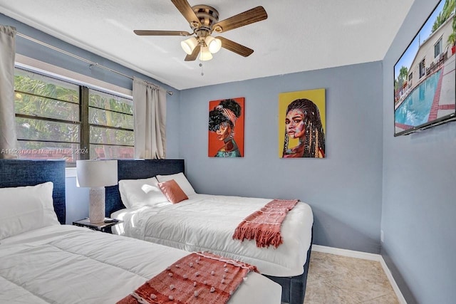 208 SW 2nd Ave, Hallandale Beach, FL 33009 - tiled bedroom featuring baseboards and ceiling fan