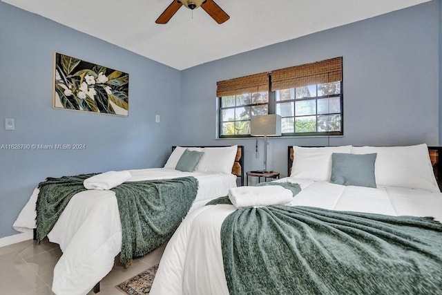 208 SW 2nd Ave, Hallandale Beach, FL 33009 - tiled bedroom featuring a ceiling fan and baseboards
