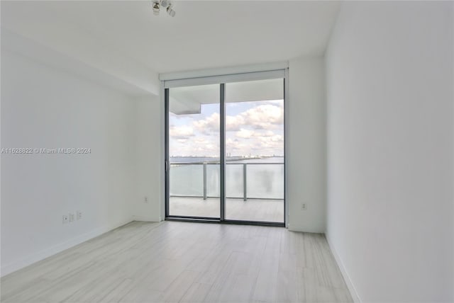 spare room with light hardwood / wood-style flooring