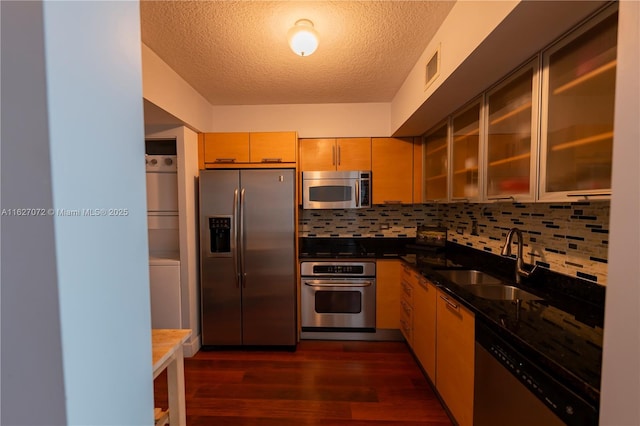 31 SE 5th St Unit 3008, Miami, FL 33131 - kitchen featuring appliances with stainless steel finishes, a textured ceiling, dark wood finished floors, decorative backsplash, and glass insert cabinets
