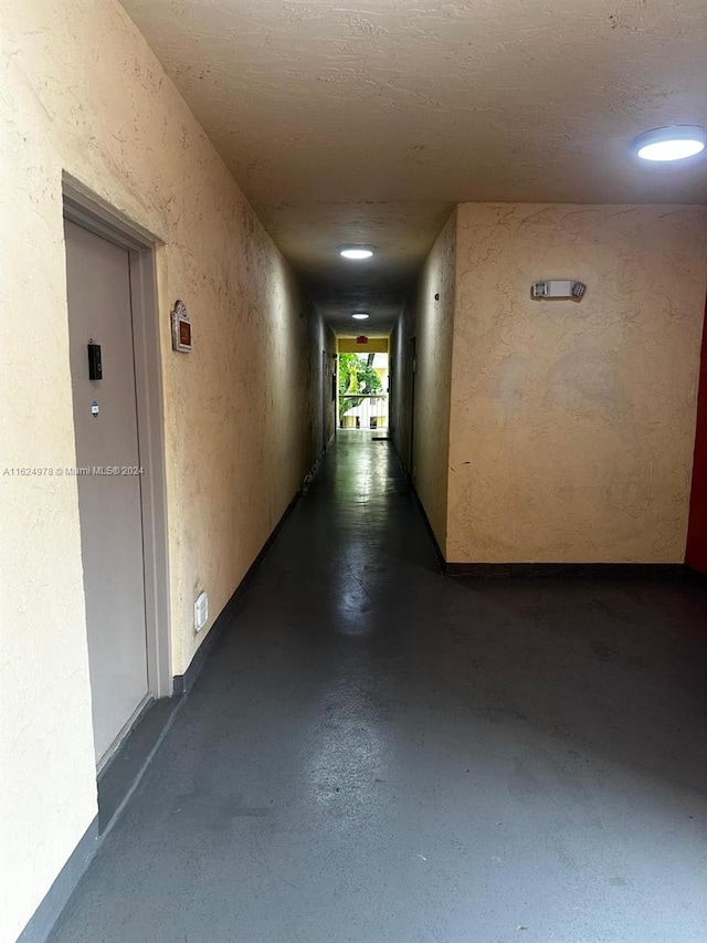 corridor with a textured ceiling