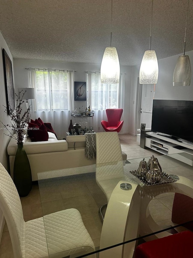 living room with light tile patterned floors and a textured ceiling