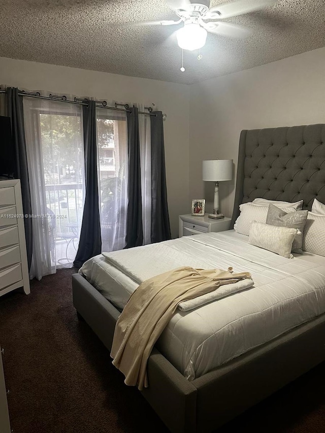 carpeted bedroom featuring ceiling fan and a textured ceiling