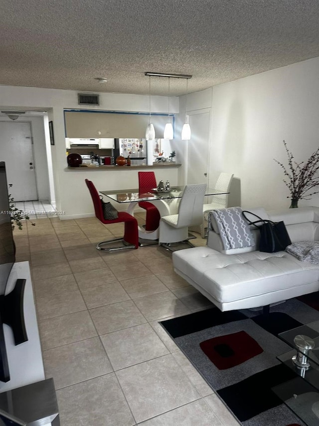 living room featuring light tile patterned floors and a textured ceiling