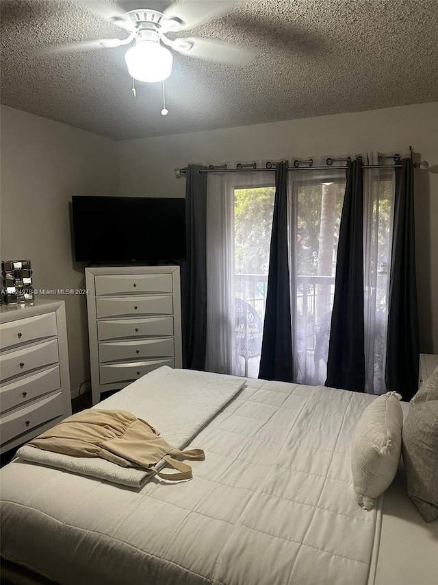 bedroom with a textured ceiling and ceiling fan