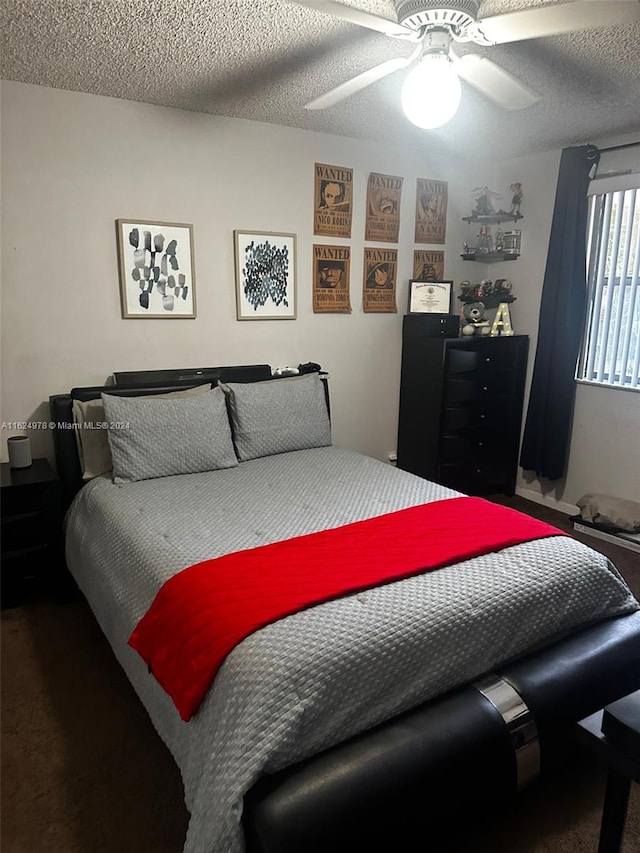 carpeted bedroom with ceiling fan and a textured ceiling