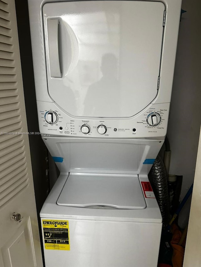 washroom featuring stacked washer / dryer