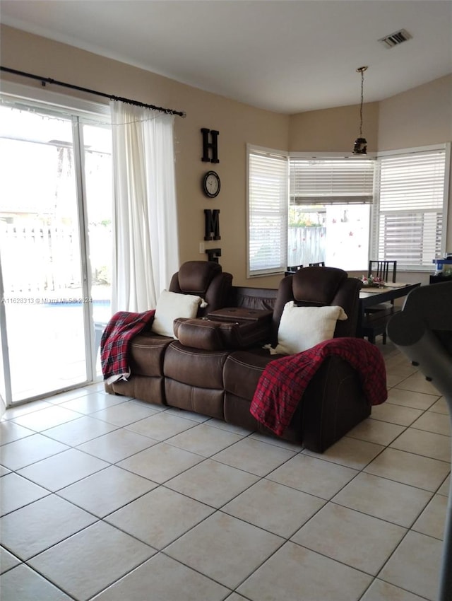 tiled living room with a healthy amount of sunlight