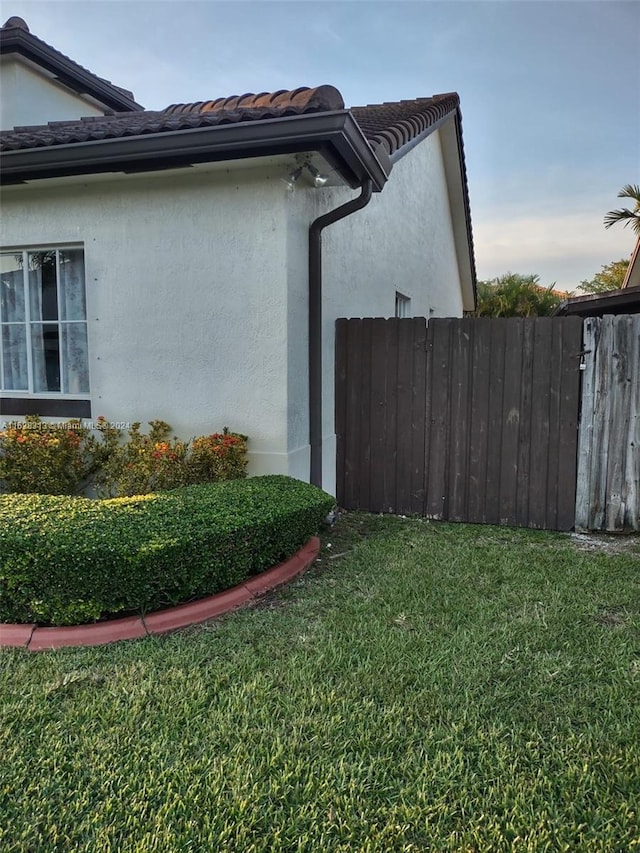 view of side of home with a lawn