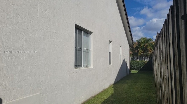 view of home's exterior with a yard