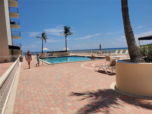 view of swimming pool featuring a water view