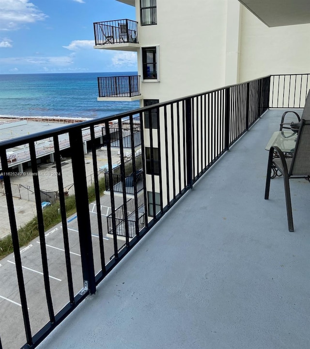 balcony with a view of the beach and a water view