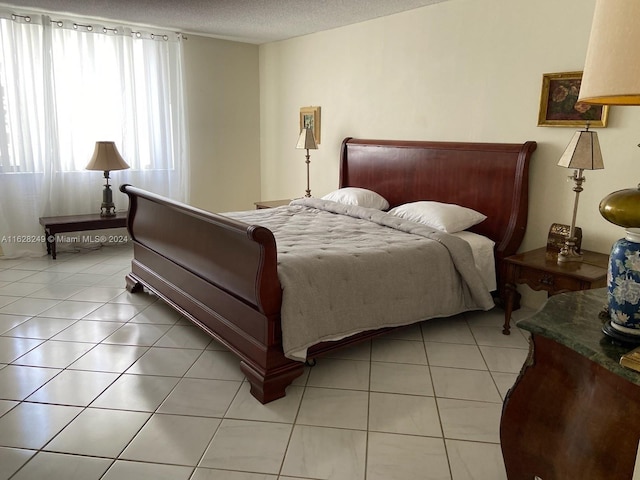 tiled bedroom featuring a textured ceiling