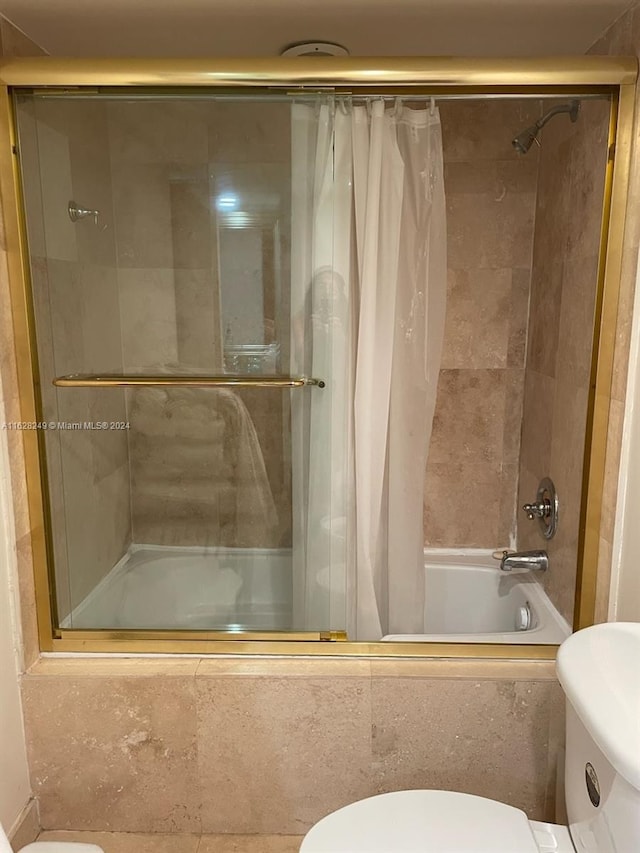 bathroom with toilet and shower / tub combo