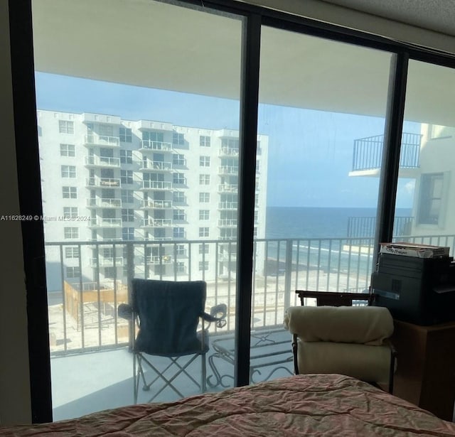 bedroom with a water view and multiple windows