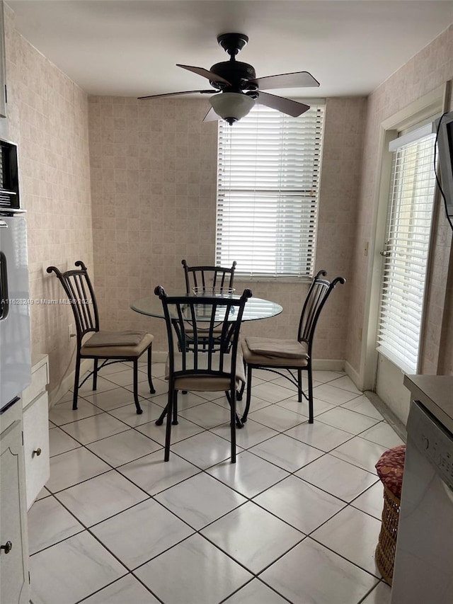 dining room with ceiling fan and light tile patterned flooring