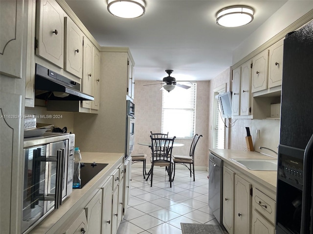 kitchen featuring black appliances, ceiling fan, sink, and light tile patterned floors