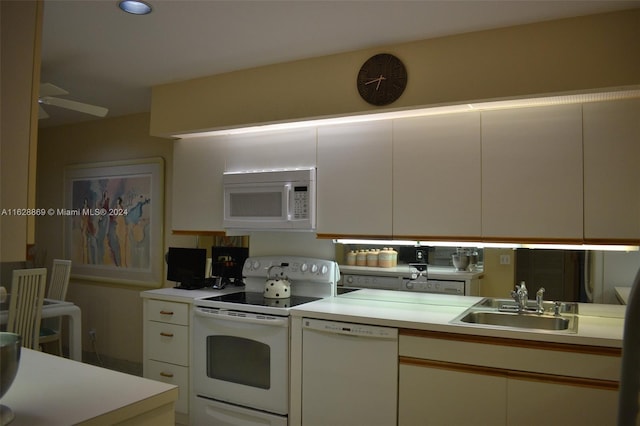 kitchen featuring sink, white cabinetry, ceiling fan, and white appliances