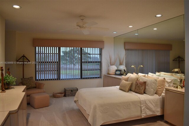 bedroom featuring light carpet and ceiling fan