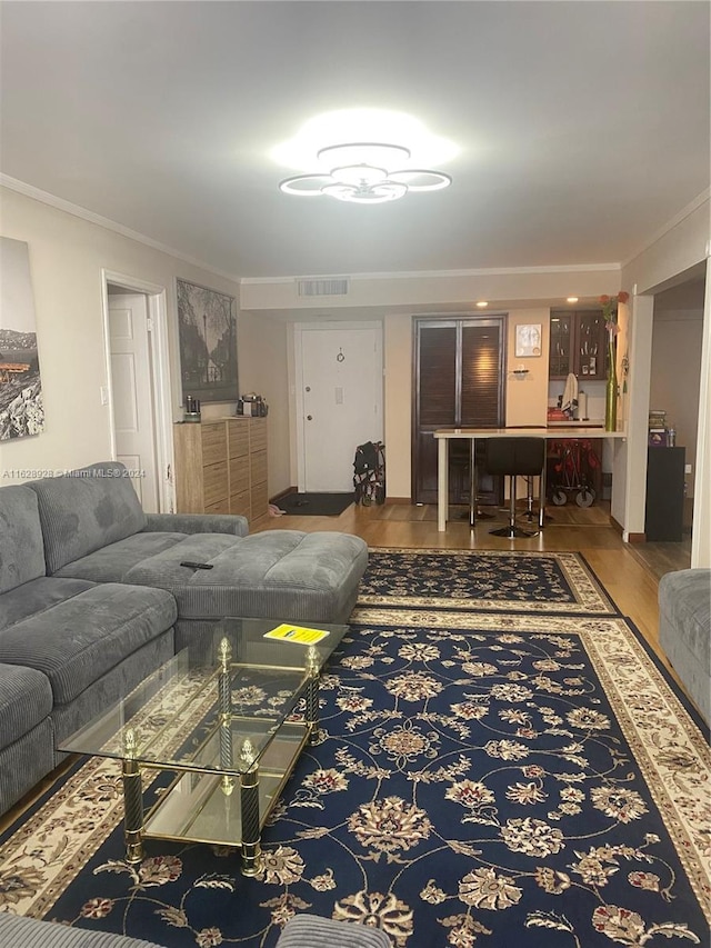 living room featuring hardwood / wood-style flooring and ornamental molding