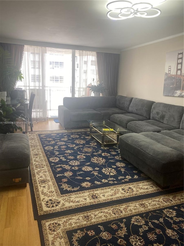 living room with wood-type flooring and ornamental molding