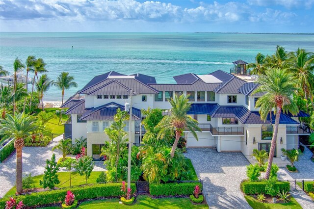 drone / aerial view featuring a water view and a view of the beach