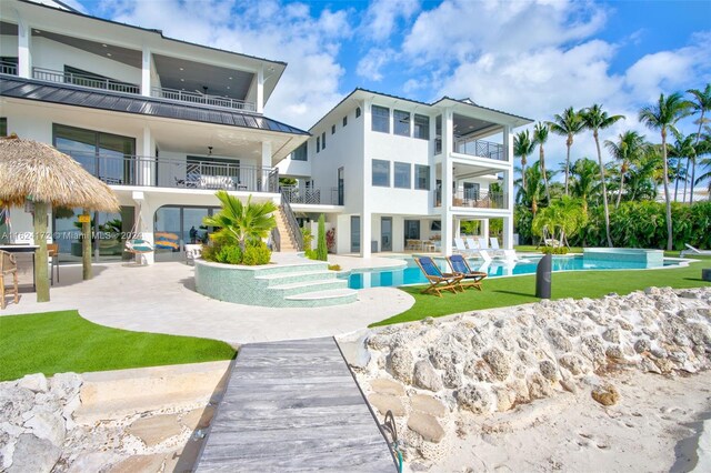 rear view of property with a patio and a balcony