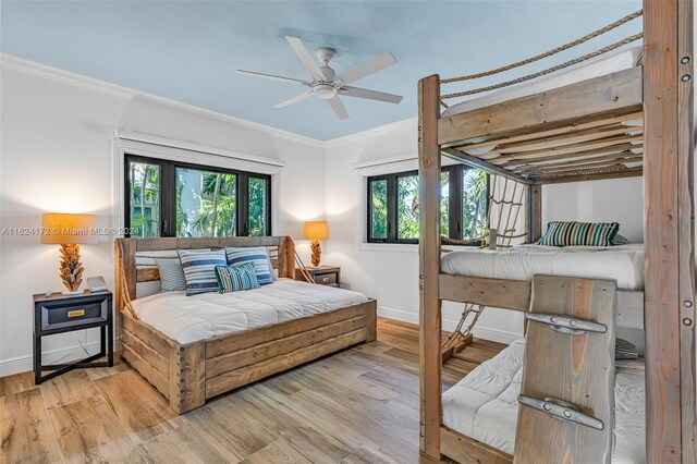 bedroom with hardwood / wood-style flooring and ornamental molding