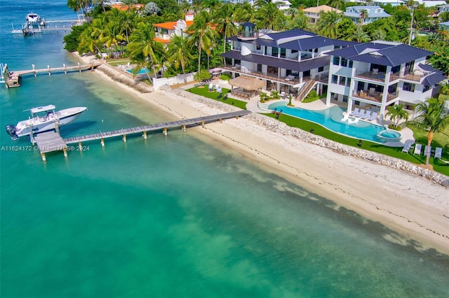 bird's eye view with a water view and a beach view