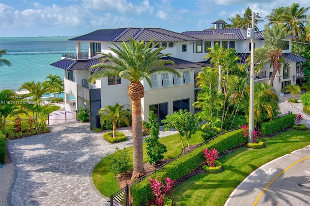 exterior space with a balcony and a water view