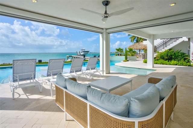 view of patio featuring a water view, outdoor lounge area, and ceiling fan