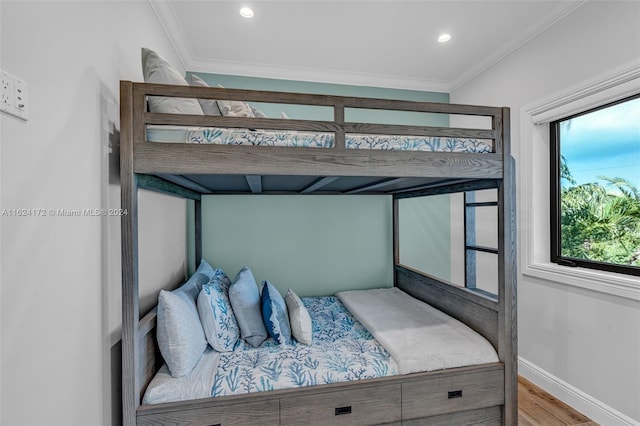 bedroom with ornamental molding and wood-type flooring