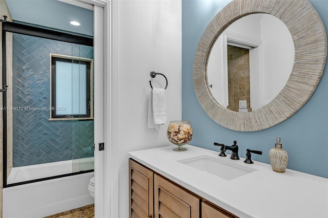 full bathroom featuring vanity, toilet, and combined bath / shower with glass door