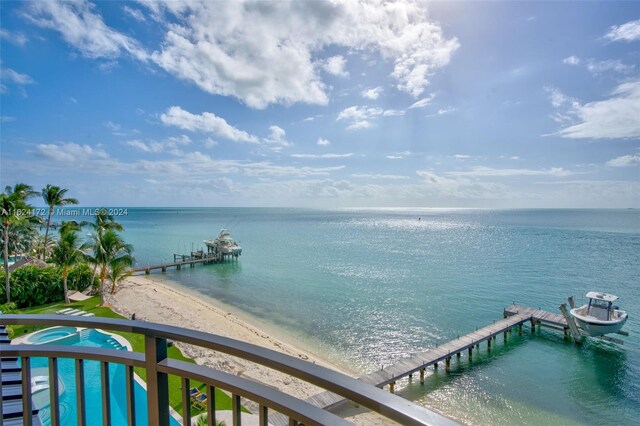 property view of water with a dock and a beach view