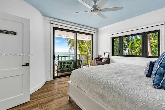 bedroom featuring dark wood-type flooring, access to outside, and ceiling fan