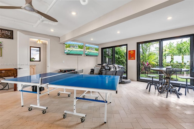 rec room featuring ceiling fan and beam ceiling