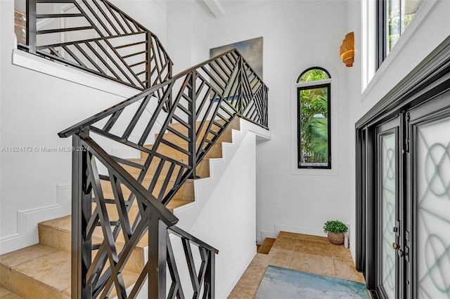 stairway featuring tile patterned flooring