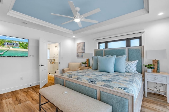 bedroom featuring wood-type flooring, ornamental molding, a raised ceiling, and ceiling fan