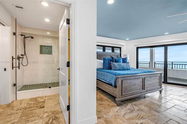 bedroom featuring access to exterior and a water view