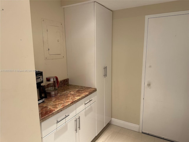 interior space featuring electric panel and tile patterned flooring