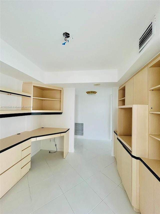 unfurnished office featuring light tile patterned floors