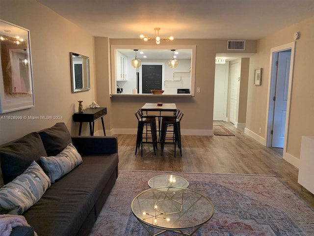 living room with hardwood / wood-style floors and a chandelier