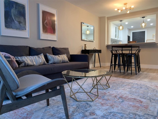 living room with a notable chandelier and light wood-type flooring