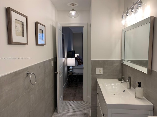 bathroom with tile walls, tile patterned floors, and vanity