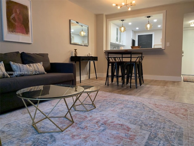 living room with wood-type flooring and a notable chandelier