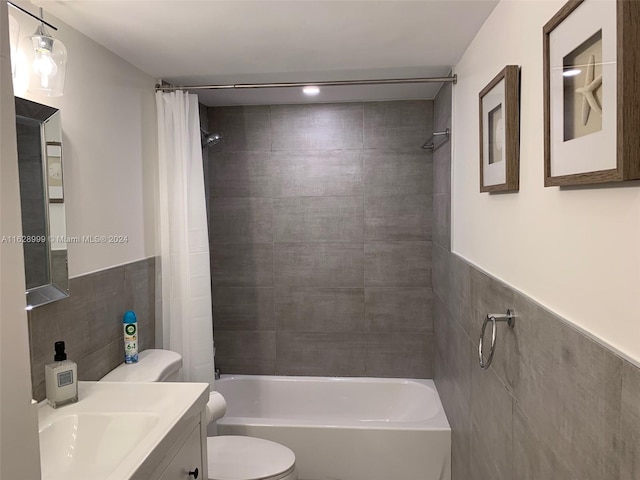 full bathroom featuring vanity, shower / bathtub combination with curtain, and toilet