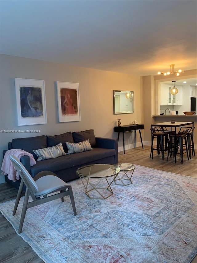 living room featuring sink and light hardwood / wood-style flooring